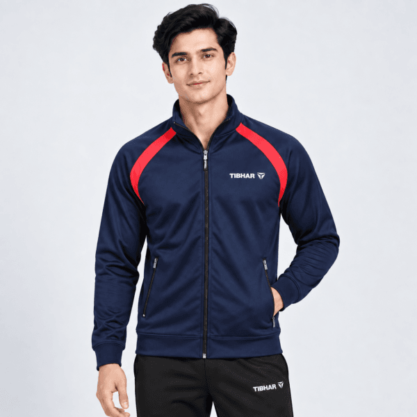 Man wearing a navy and red full zip training jacket